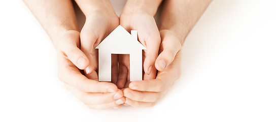 Image showing man and woman hands with white paper house