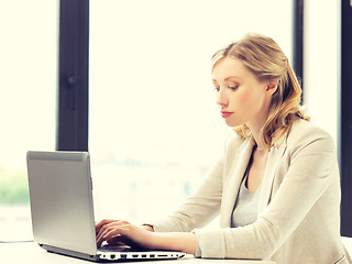 Image showing pensive woman with laptop computer