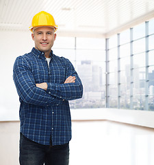 Image showing smiling male builder or manual worker in helmet