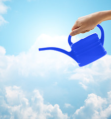 Image showing close up of woman hand holding watering can