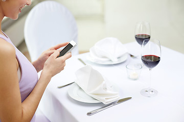 Image showing close up of woman with smartphone at restaurant