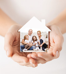 Image showing close up of hands holding house shape with family