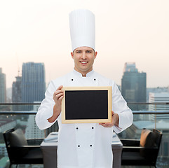 Image showing happy male chef cook holding blank menu board