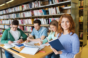 Image showing happy students reading books in library