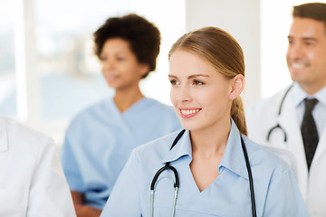 Image showing happy doctor over group of medics at hospital