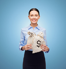 Image showing businesswoman holding money bags with euro