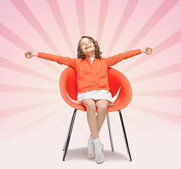 Image showing happy little girl sitting on designer chair