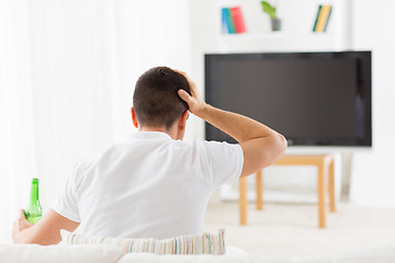 Image showing man watching tv and drinking beer at home