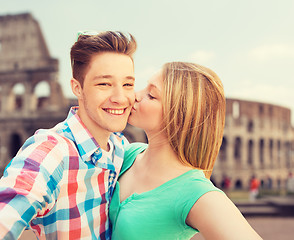 Image showing couple kissing and taking selfie over coliseum