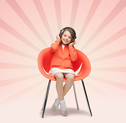 Image showing happy little girl listening to music in headphones