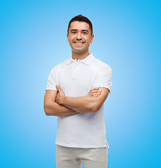 Image showing smiling man in white t-shirt with crossed arms