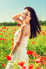 Image showing smiling young woman on poppy field