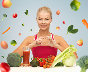 Image showing happy woman with vegetarian food showing heart