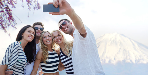 Image showing friends taking selfie with smartphone