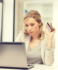 Image showing serious woman with laptop computer and credit card