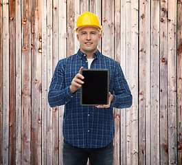 Image showing smiling male builder in helmet with tablet pc