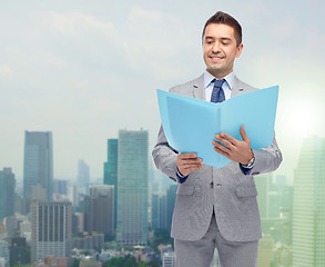 Image showing happy businessman with open folder