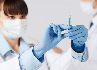 Image showing doctors with syringe