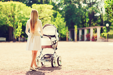 Image showing happy mother with stroller in park