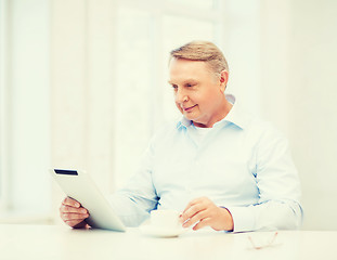 Image showing old man with tablet pc computer at home