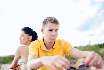 Image showing unhappy couple sitting on beach