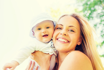 Image showing happy mother with little baby outdoors