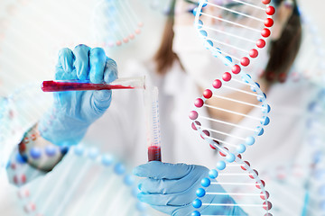 Image showing close up of scientist with tube making test in lab