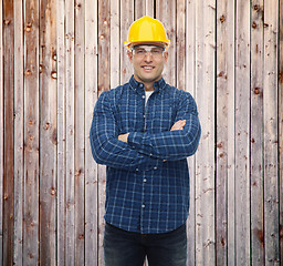 Image showing smiling male builder or manual worker in helmet