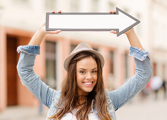 Image showing girl showing direction with arrow in the city