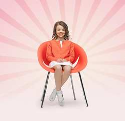 Image showing happy little girl sitting on designer chair