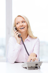 Image showing smiling businesswoman or student calling on phone