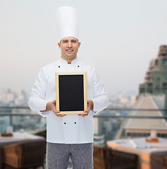 Image showing happy male chef cook holding blank menu board