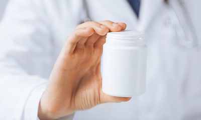 Image showing doctor hands holding white pack