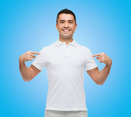 Image showing smiling man in t-shirt pointing fingers on himself