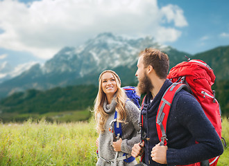 Image showing smiling couple with backpacks hiking