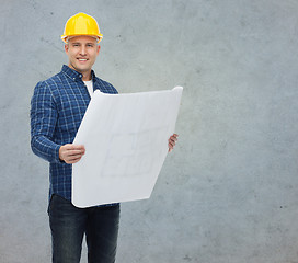 Image showing smiling male builder in helmet with blueprint