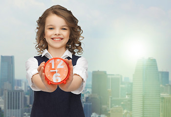 Image showing happy girl with alarm clock 