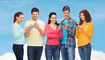 Image showing group of smiling teenagers with smartphones