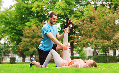 Image showing smiling couple stretching outdoors