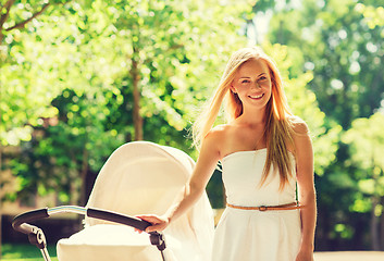 Image showing happy mother with stroller in park