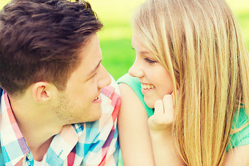 Image showing smiling couple looking at each other in park