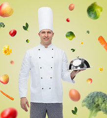 Image showing happy male chef cook holding cloche