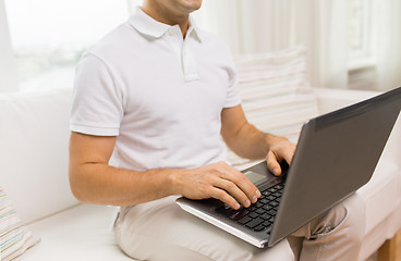 Image showing close up of man working with laptop at home