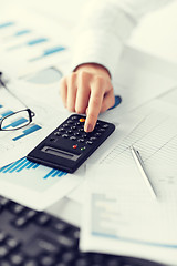 Image showing woman hand with calculator and papers