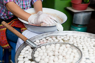 Image showing close up of cook frying meatballs at street market