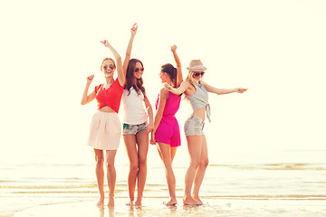 Image showing group of smiling women dancing on beach