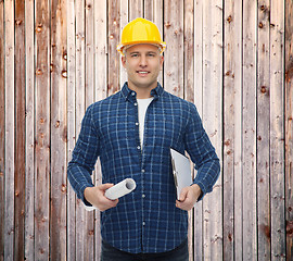 Image showing smiling male builder in helmet with blueprint