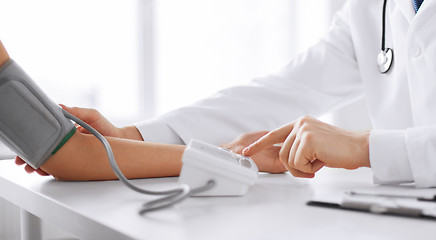 Image showing doctor and patient measuring blood pressure