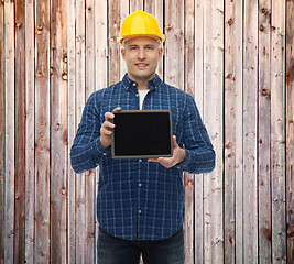 Image showing smiling male builder in helmet with tablet pc