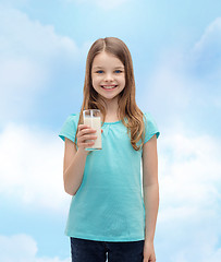 Image showing smiling little girl with glass of milk